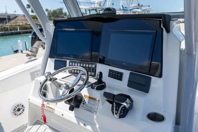 Slide: The Image of 2025 Sea Fox 328 Commander helm with dual screens and modern controls. - 14