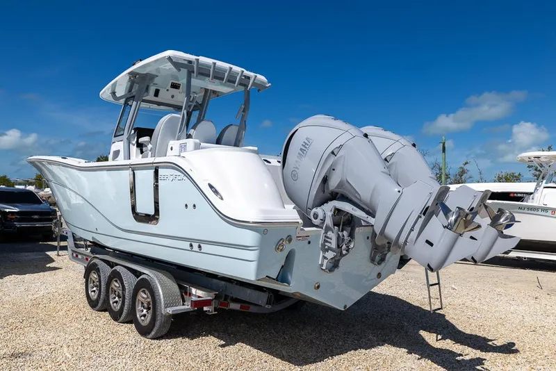 Slide: The Image of 2025 Sea Fox 328 Commander boat on trailer under clear blue sky. - 3
