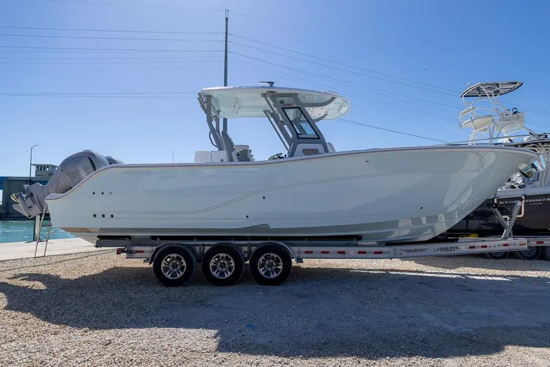 Slide: The Image of 2025 Sea Fox 328 Commander boat on trailer, featuring dual outboard engines. - 7