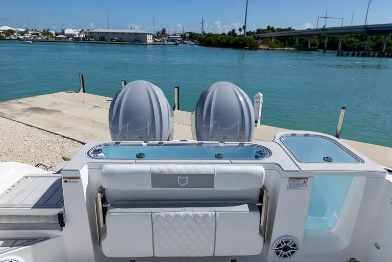 Slide: The Image of 2025 Sea Fox 328 Commander boat docked by the water, showcasing dual engines. - 8