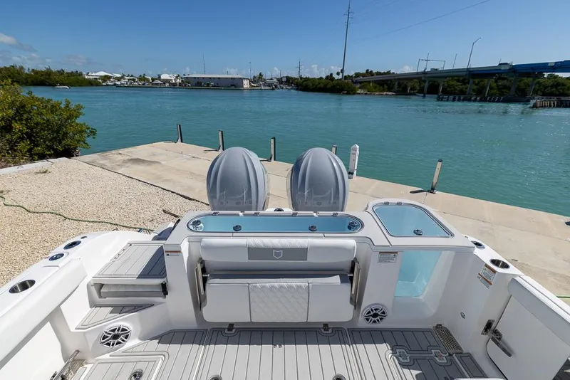 Slide: The Image of 2025 Sea Fox 328 Commander boat interior with seating, overlooking a serene waterfront. - 9