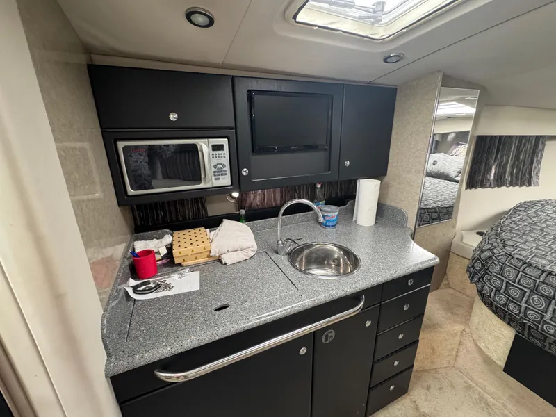 Slide: The Image of Interior of 2005 Formula 34 PC yacht with bed, kitchenette, and seating area. - 13