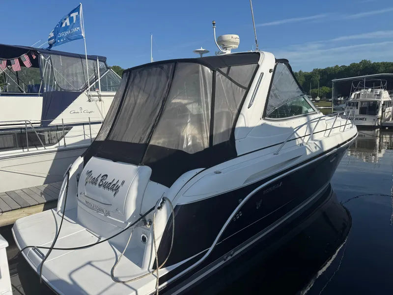 Slide: The Image of 2005 Formula 34 PC boat docked, rear view with "Yeah Buddy" text, in a marina setting. - 2