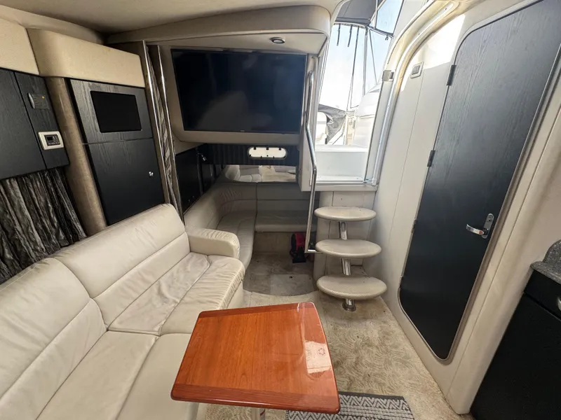 Slide: The Image of 2005 Formula 34 PC boat bathroom with sink, toilet, and storage shelves. - 20