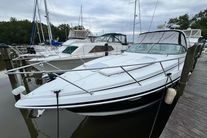 Slide: The Image of 2005 Formula 34 Performance Cruiser docked at marina, surrounded by other boats. - 29