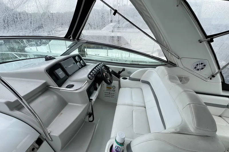 Slide: The Image of 2005 Formula 34 Performance Cruiser cockpit with white seating and control panel. - 33