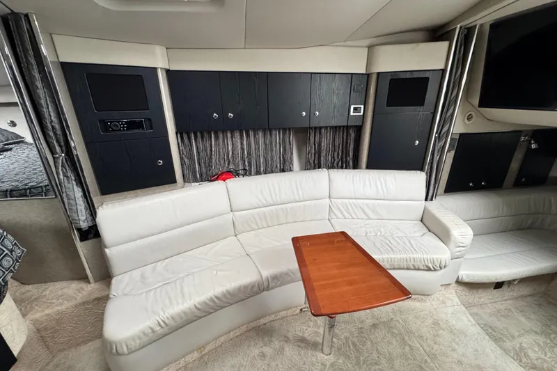 Slide: The Image of 2005 Formula 34 Performance Cruiser interior with white leather seating and wooden table. - 35