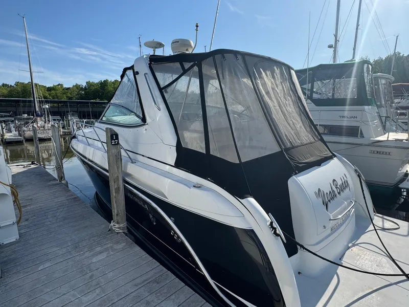 Slide: The Image of 2005 Formula 34 PC boat interior with white seating and cushions. - 4