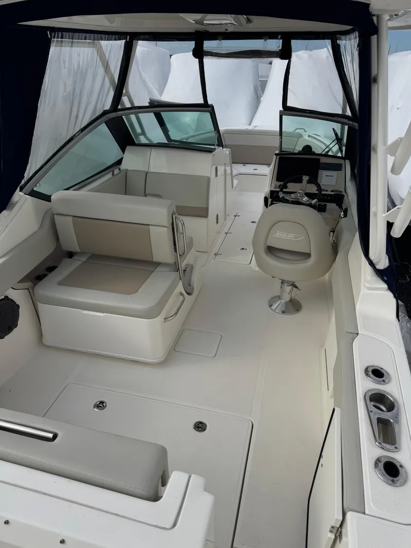 Slide: The Image of 2022 Boston Whaler 240 Vantage interior, featuring seating and helm area. - 10