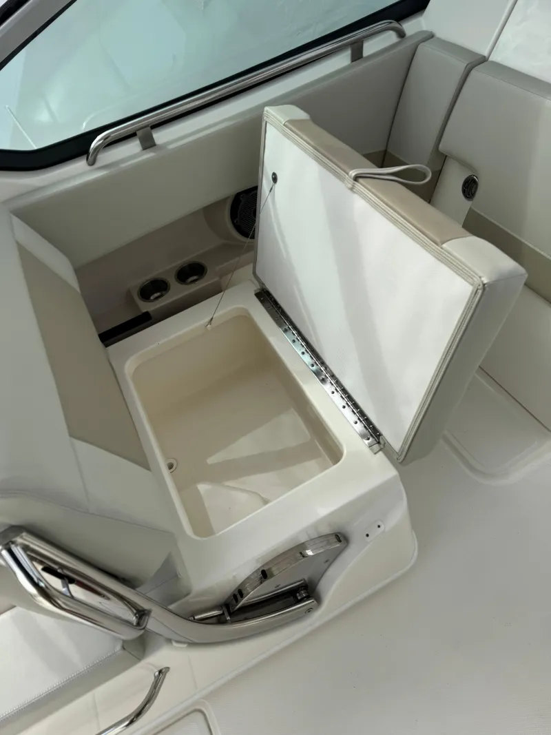 Slide: The Image of 2022 Boston Whaler 240 Vantage boat storage compartment with open lid. - 11