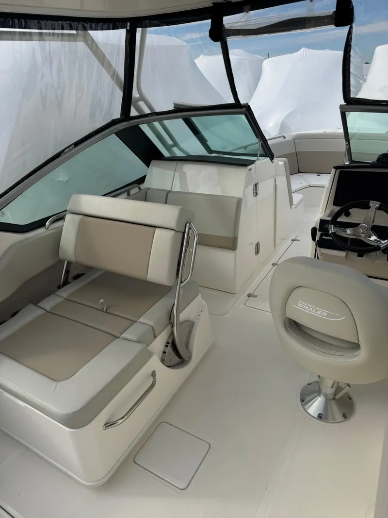 Slide: The Image of 2022 Boston Whaler 240 Vantage interior with seating and helm, showcasing modern design. - 13