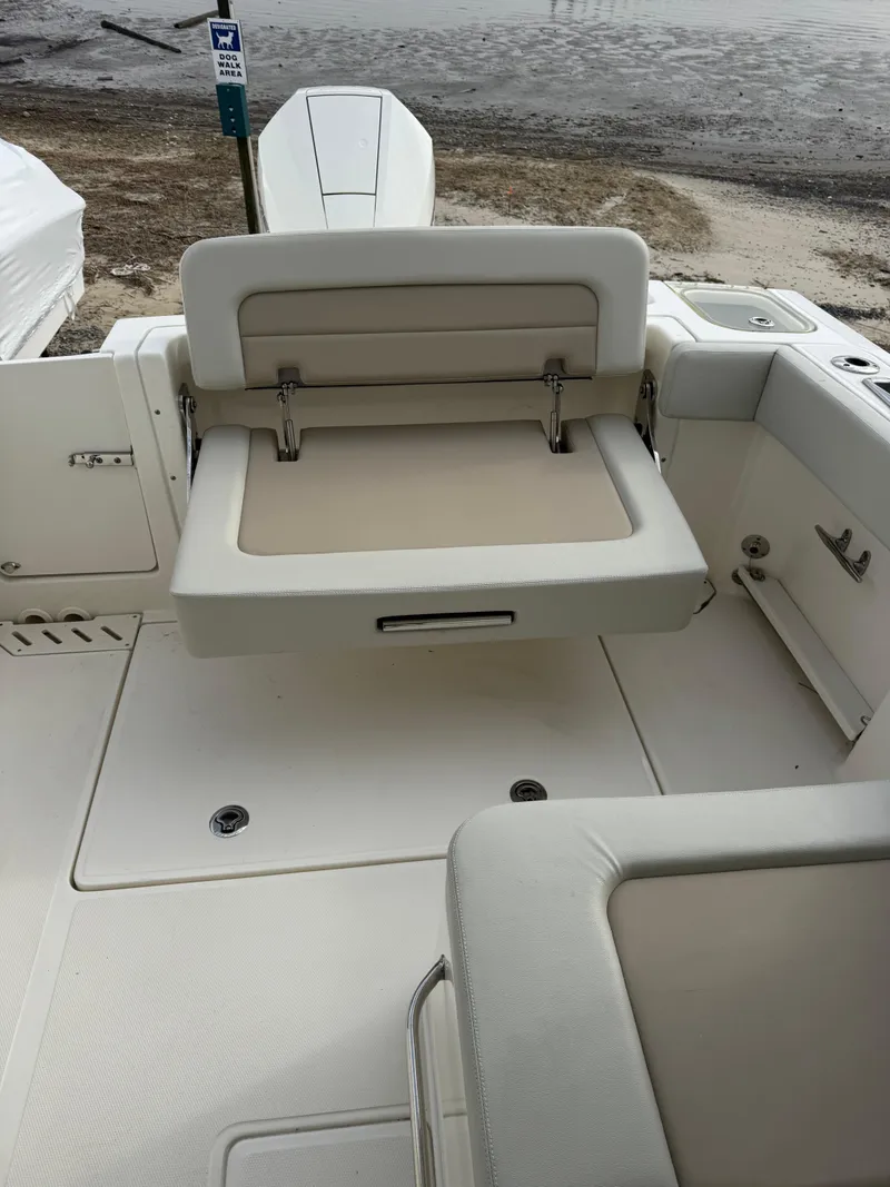 Slide: The Image of 2022 Boston Whaler 240 Vantage boat interior with foldable seating and storage. - 15