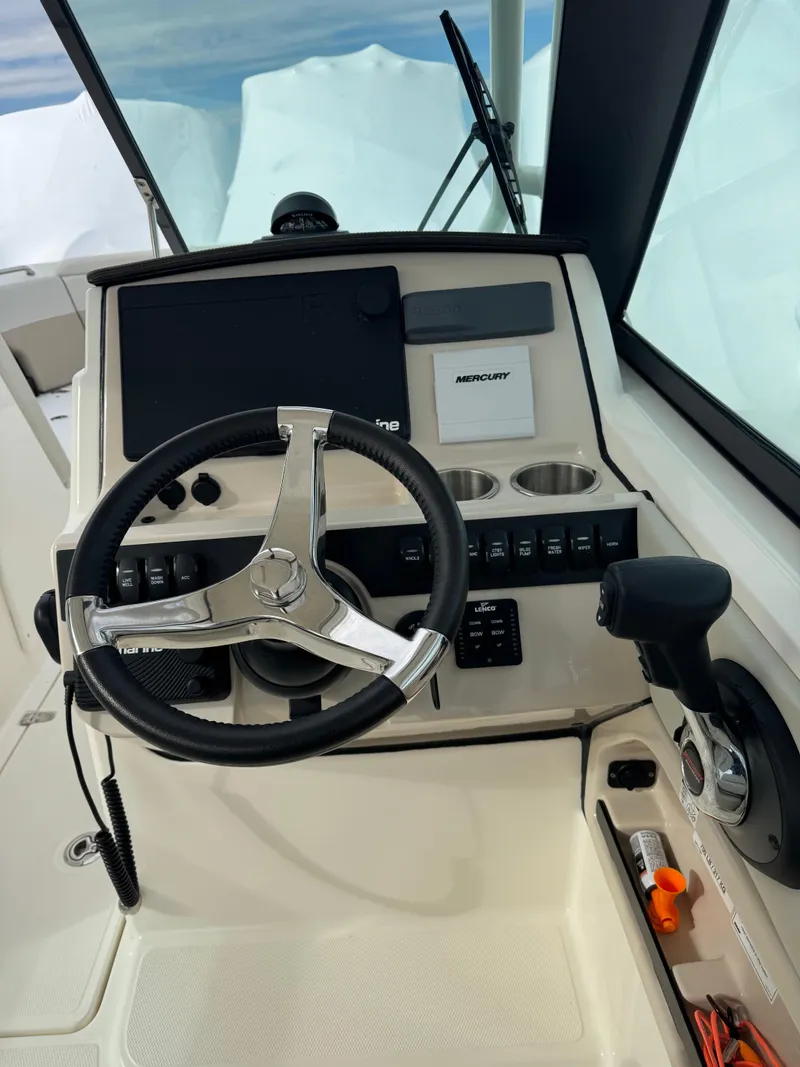 Slide: The Image of 2022 Boston Whaler 240 Vantage helm with steering wheel and controls. - 4