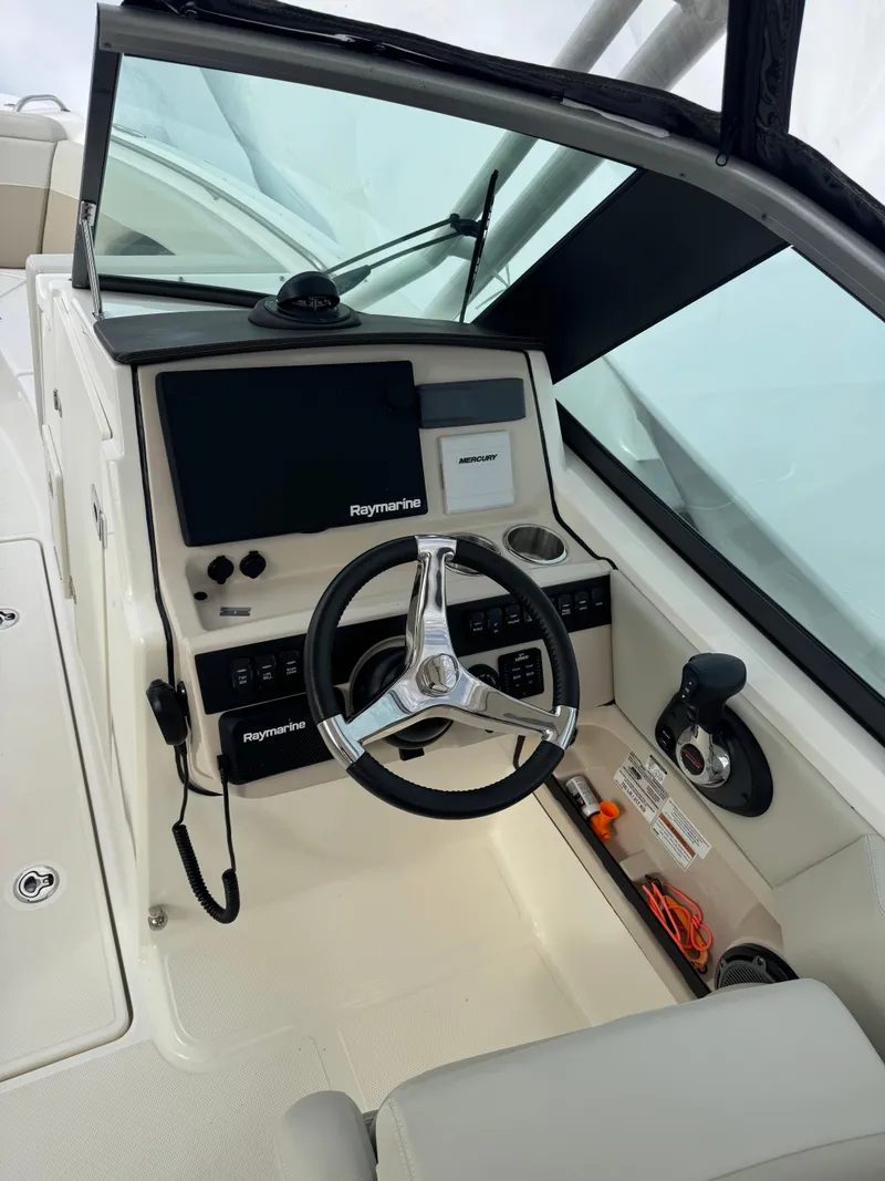 Slide: The Image of 2022 Boston Whaler 240 Vantage boat cockpit with steering wheel and control panel. - 5