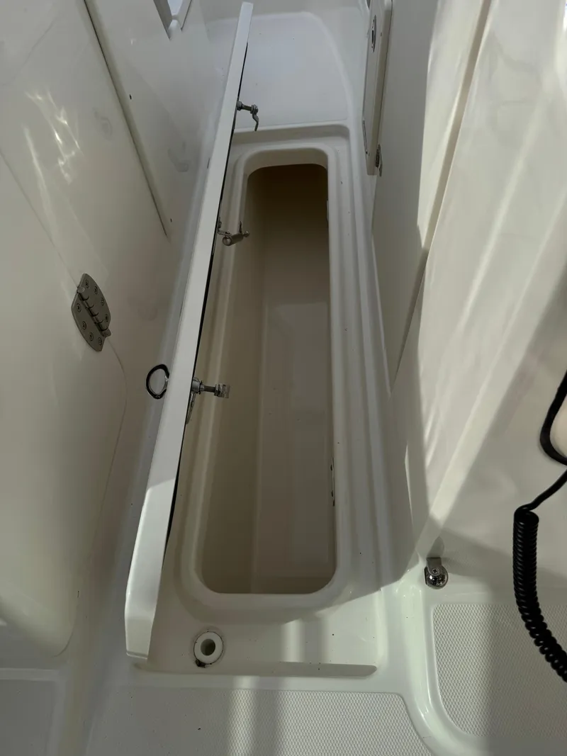 Slide: The Image of 2022 Boston Whaler 240 Vantage storage compartment, open and empty, showcasing interior space. - 6