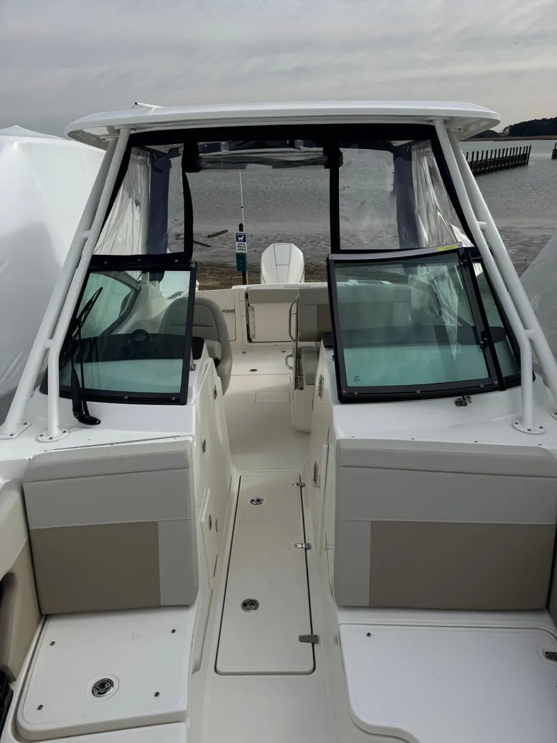 Slide: The Image of 2022 Boston Whaler 240 Vantage boat with dual consoles, docked by the water. - 9