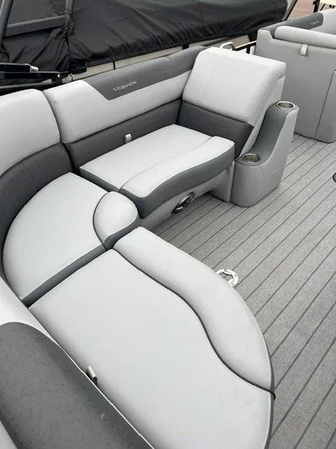 Slide: The Image of 2025 Veranda VF22F2 Deluxe boat interior with gray cushioned seating and cup holders. - 3