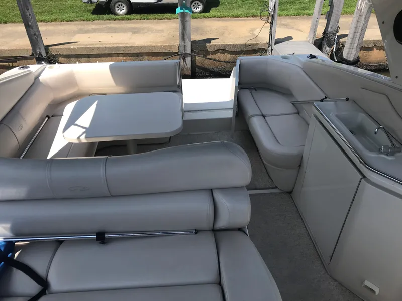 Slide: The Image of 1999 Regal 322 Commodore boat interior with white seating and table. - 3