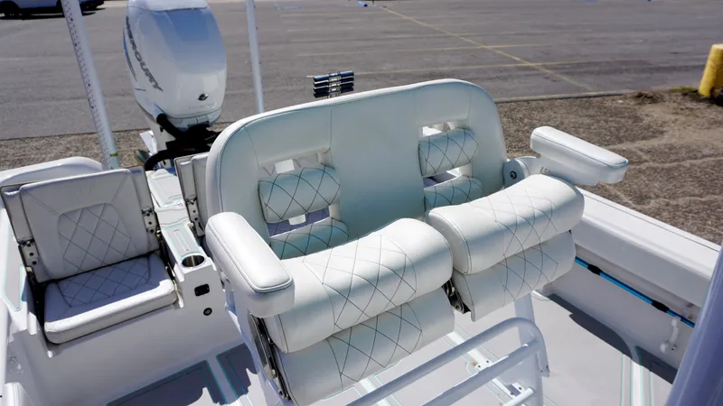 Slide: The Image of 2022 Blue Wave 2600 PureBay boat seating with white cushioned armrests and diamond stitching. - 14