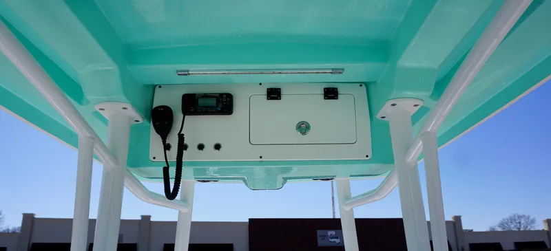 Slide: The Image of 2022 Blue Wave 2600 PureBay boat console with radio and storage compartment. - 15