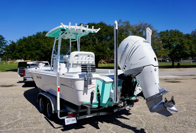 Slide: The Image of 2022 Blue Wave 2600 PureBay boat on trailer with outboard motor in parking lot. - 6