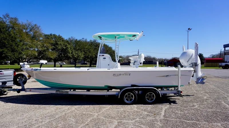 Slide: The Image of 2022 Blue Wave 2600 PureBay boat on trailer in outdoor setting. - 7