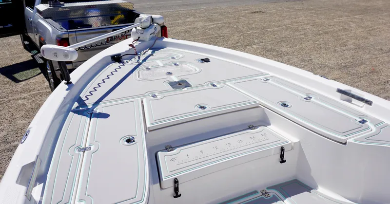 Slide: The Image of 2022 Blue Wave 2600 PureBay boat deck with storage compartments and fishing equipment. - 9