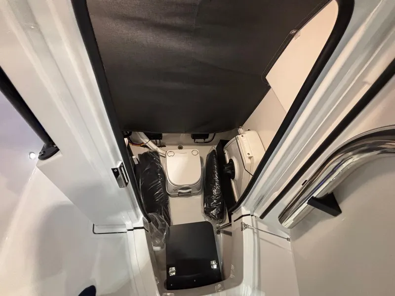 Slide: The Image of 2025 Blackfin 222 CC boat interior cabin with compact toilet and storage. - 10