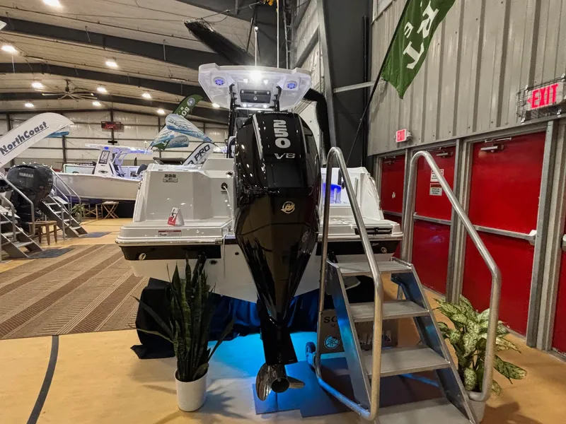 Slide: The Image of 2025 Blackfin 222 CC boat with powerful engine displayed indoors. - 2