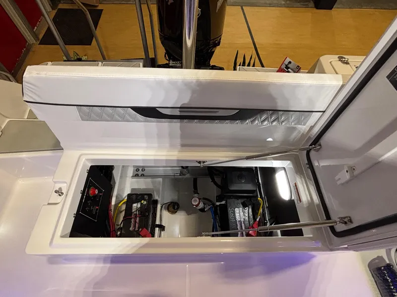 Slide: The Image of 2025 Blackfin 222 CC boat battery compartment with open hatch, showcasing internal components. - 5