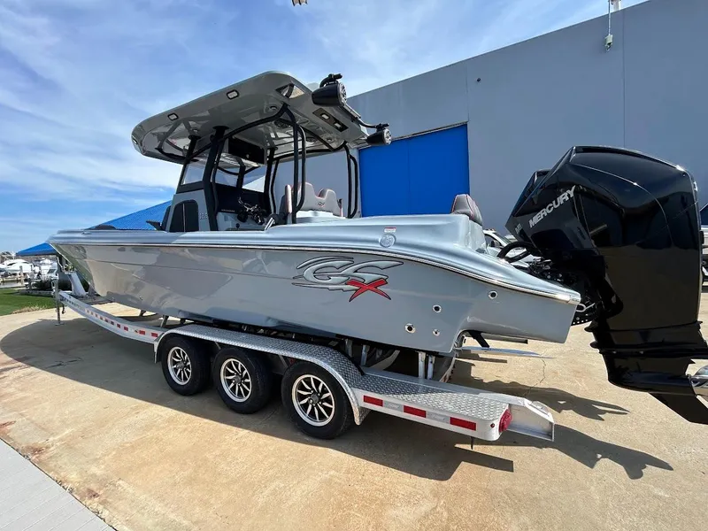Slide: The Image of 2024 Glasstream 32 GSX boat on trailer, featuring sleek design and powerful outboard engines. - 1
