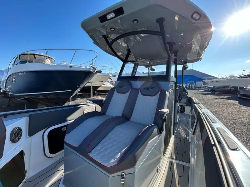 Slide: The Image of 2024 Glasstream 32 GSX boat with modern seating and sleek design in a marina. - 30