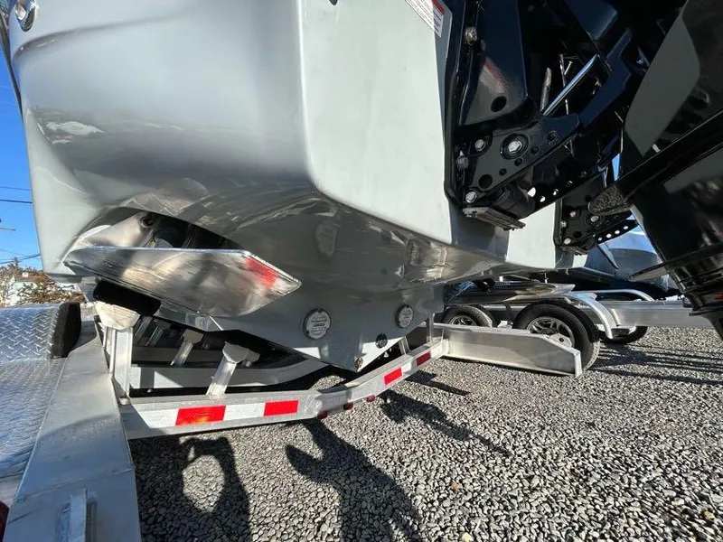 Slide: The Image of 2024 Glasstream 32 GSX boat on trailer, showing hull and outboard motor details. - 11