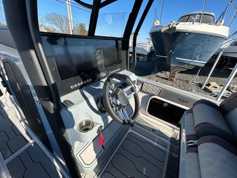 Slide: The Image of 2024 Glasstream 32 GSX boat interior with steering wheel and dashboard controls. - 19