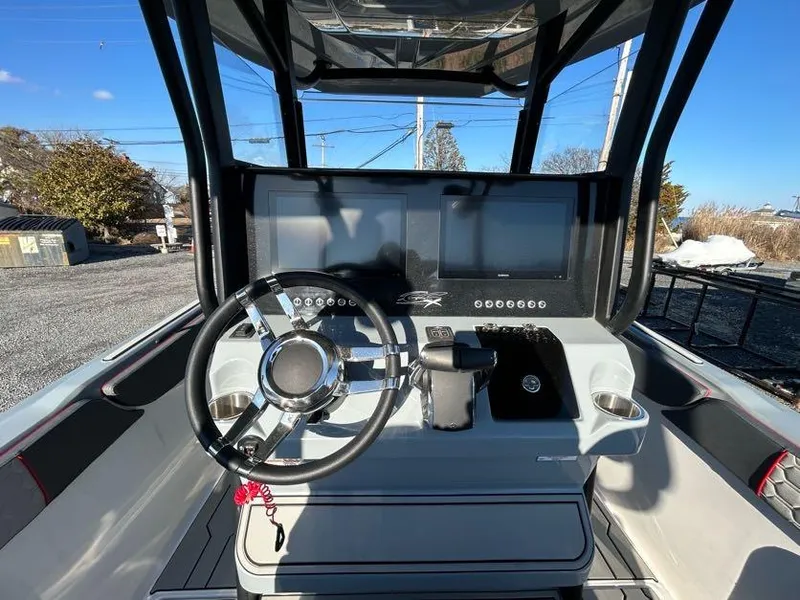 Slide: The Image of 2024 Glasstream 32 GSX boat dashboard with steering wheel and dual screens. - 21