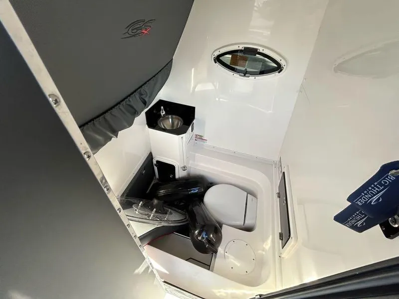 Slide: The Image of 2024 Glasstream 32 GSX boat interior with compact bathroom and sink. - 24