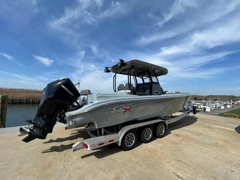 Slide: The Image of 2024 Glasstream 32 GSX boat on trailer, dockside, under clear blue sky. - 3