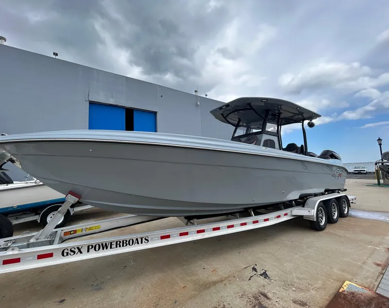 Slide: The Image of 2024 Glasstream 32 GSX powerboat on trailer, parked outdoors under cloudy sky. - 4