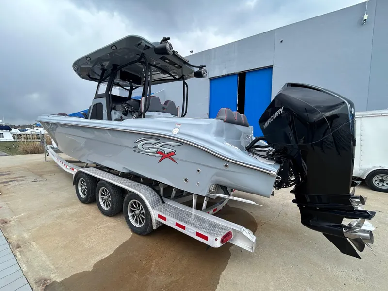 Slide: The Image of 2024 Glasstream 32 GSX boat on trailer, featuring sleek design and powerful outboard engine. - 5