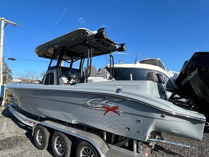 Slide: The Image of 2024 Glasstream 32 GSX boat on trailer, sleek design, gray color, outdoor display. - 7