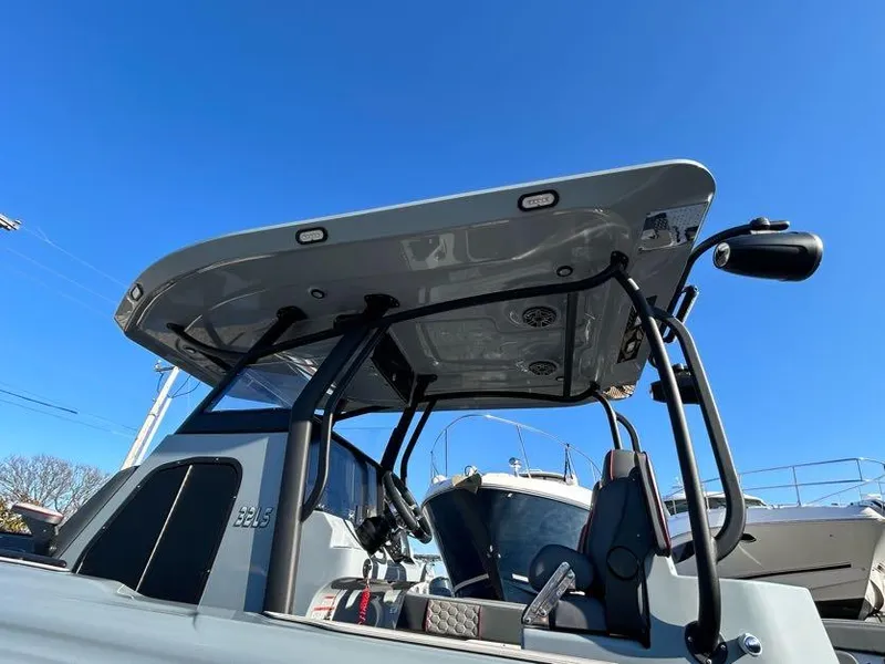 Slide: The Image of 2024 Glasstream 32 GSX boat with sleek design and modern features under clear blue sky. - 9