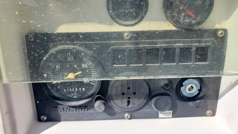 Slide: The Image of Dashboard of a 1999 Beneteau Oceanis 44 CC sailboat with gauges and controls. - 12