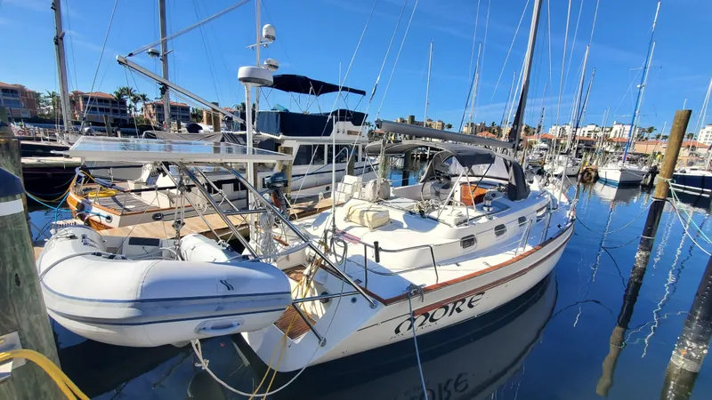 Slide: The Image of 1999 Beneteau Oceanis 44 CC sailboat docked in a marina, surrounded by other boats. - 2