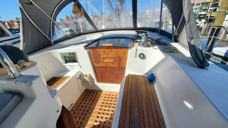 Slide: The Image of 1999 Beneteau Oceanis 44 CC cockpit with wooden flooring and covered seating area. - 20