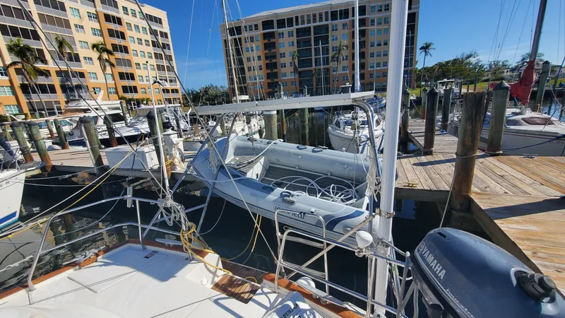 Slide: The Image of Beneteau Oceanis 44 CC 1999 docked at marina with nearby buildings. - 21