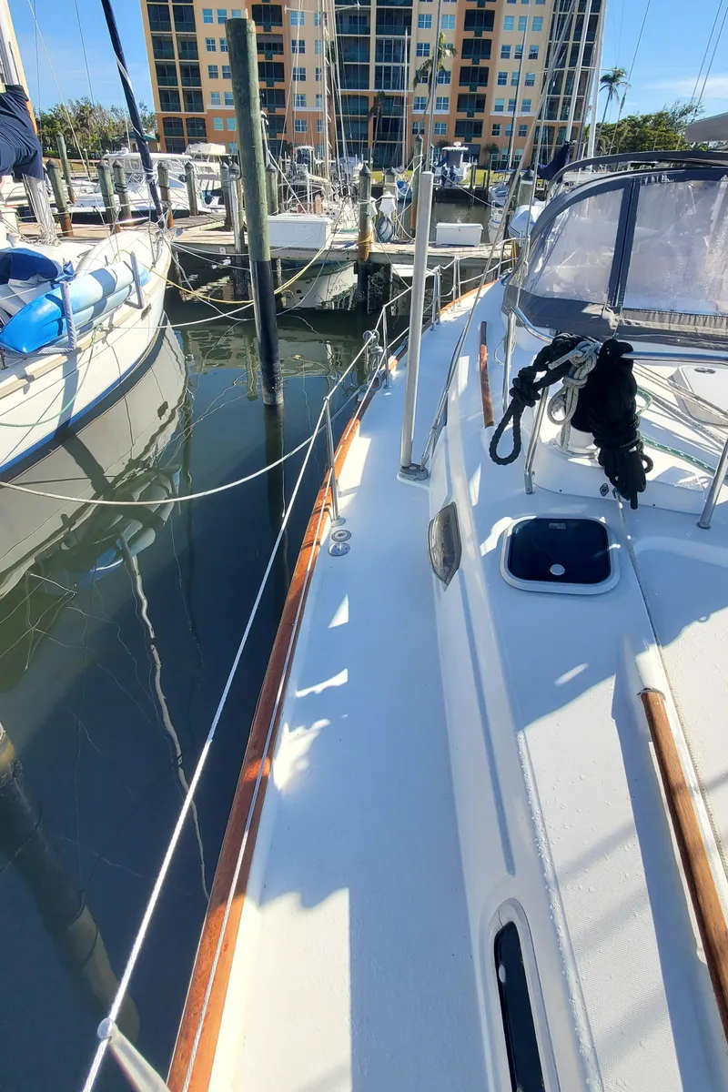 Slide: The Image of 1999 Beneteau Oceanis 44 CC sailboat docked at marina, side deck view. - 27