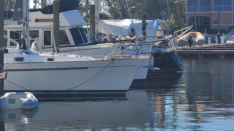 Slide: The Image of Beneteau Oceanis 44 CC 1999 sailboat docked in a marina, calm water reflections. - 3