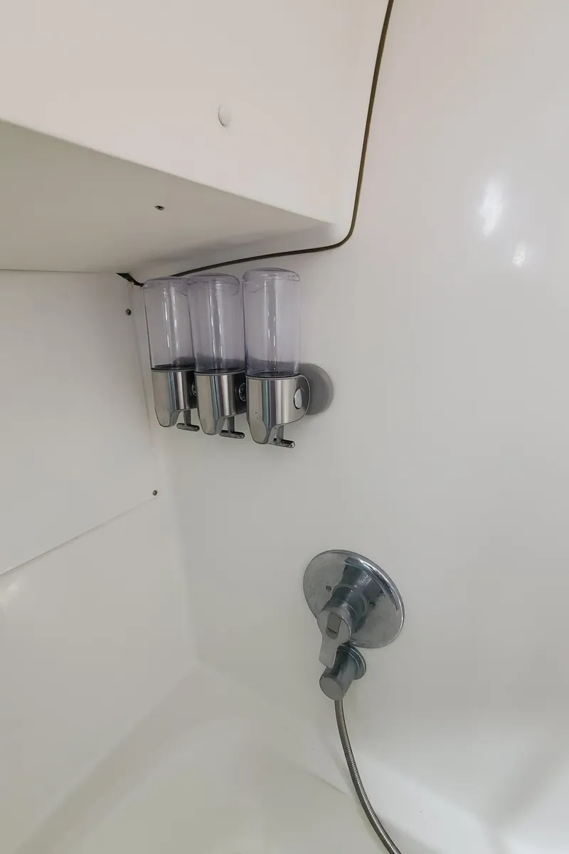 Slide: The Image of Shower area in 1999 Beneteau Oceanis 44 CC yacht with dispensers and chrome fixtures. - 38
