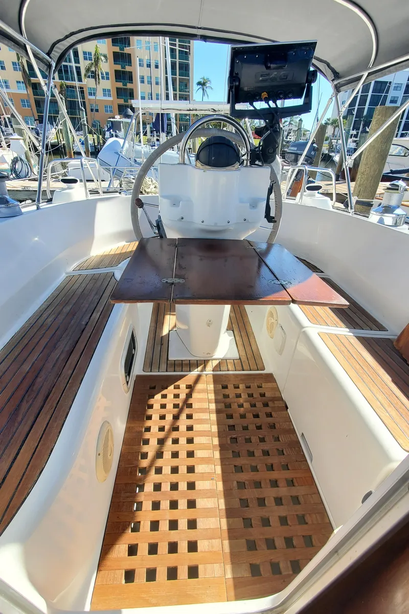 Slide: The Image of Cockpit of 1999 Beneteau Oceanis 44 CC sailboat with wooden flooring and steering wheel. - 45