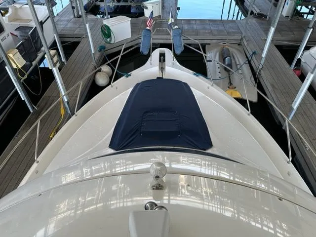 Slide: The Image of 1998 Silverton 372 Motor Yacht docked, top view with covered deck and surrounding marina. - 15
